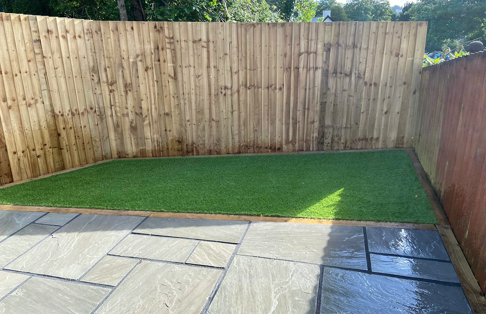 New feather-edge fence, artificial grass and a sandstone patio
